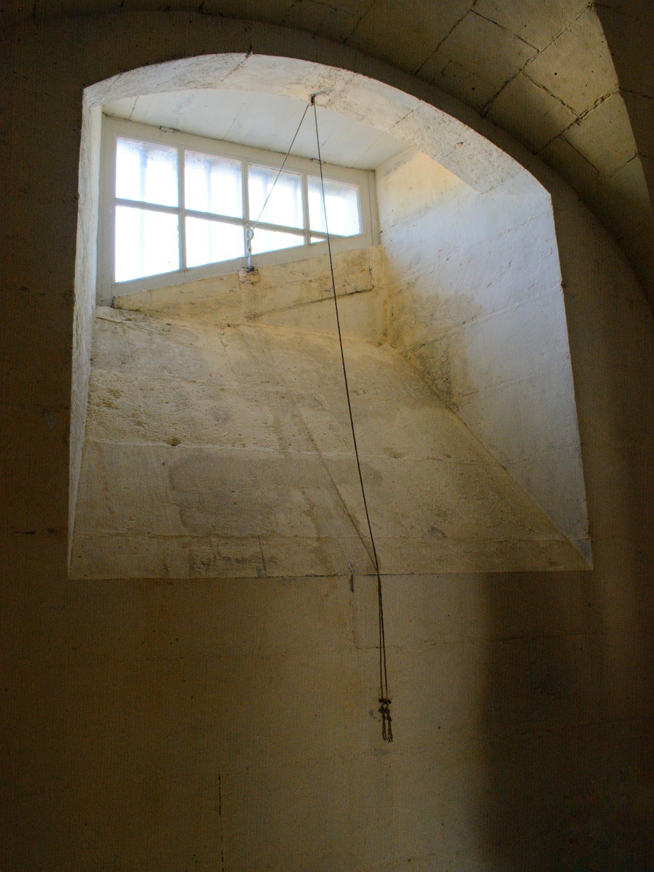 A window shaped ominously like a guillotine