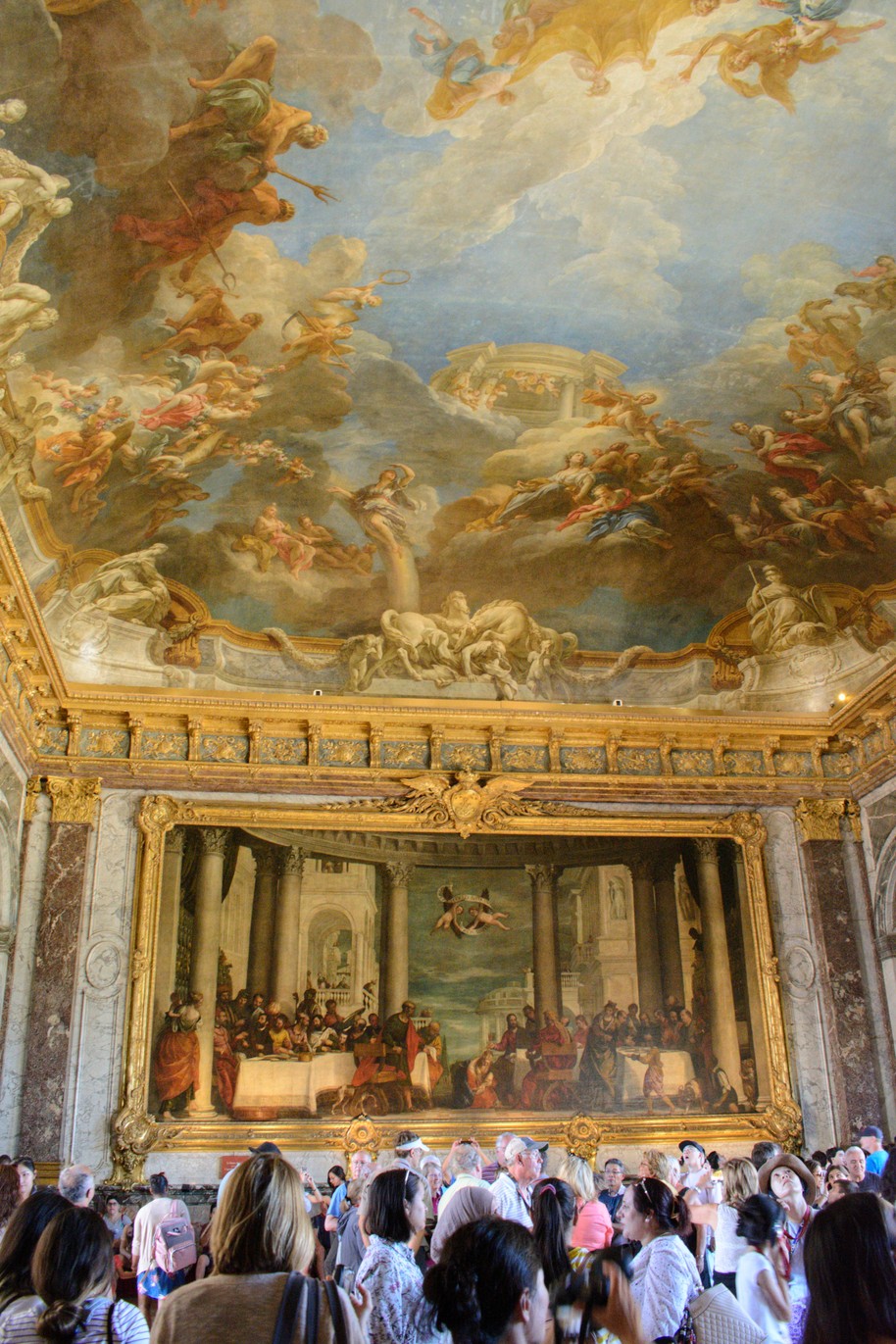 Paintings over the crowd in the palace at Versaille